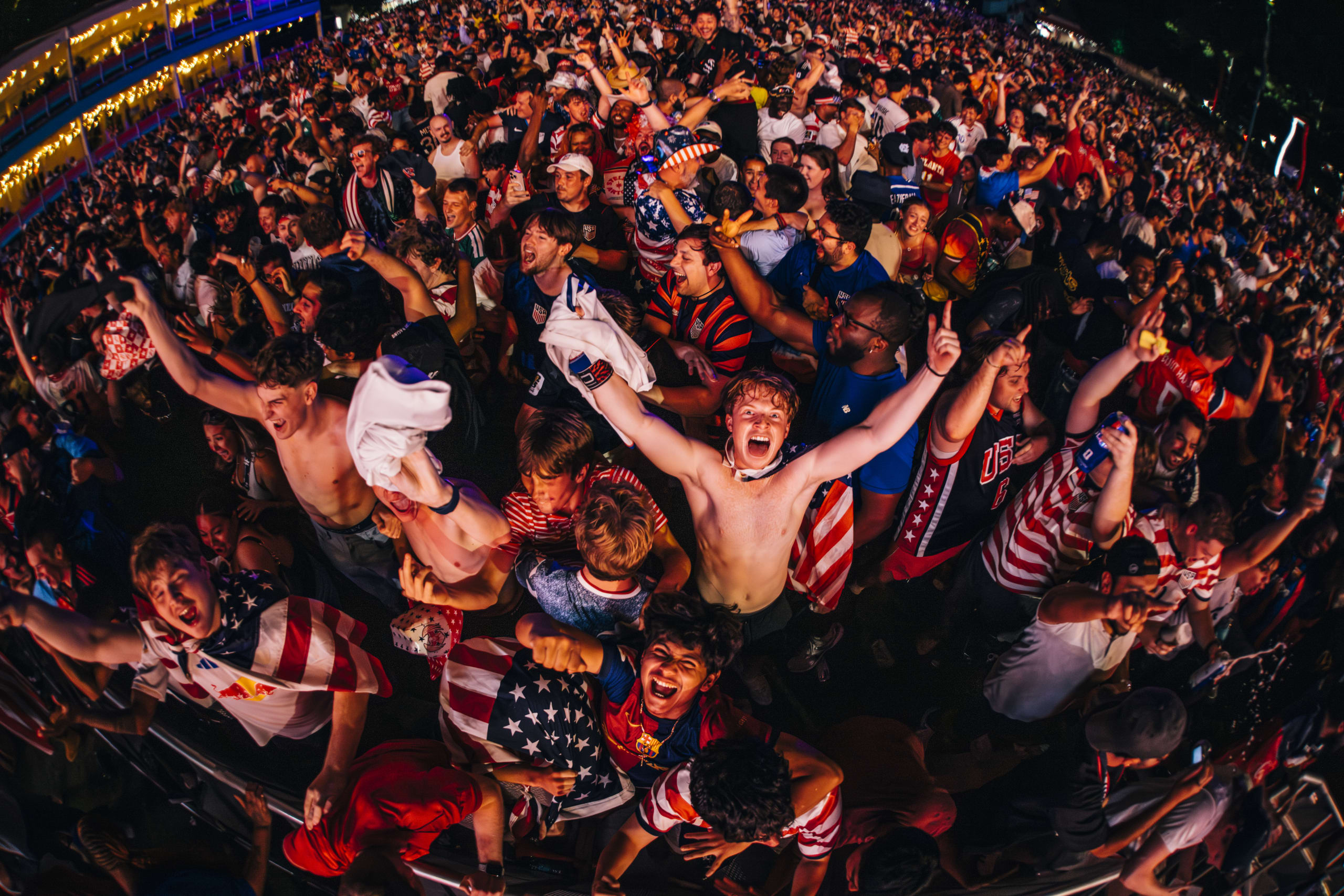 Fans celebrating at a FIFA Fan Fest watch party.