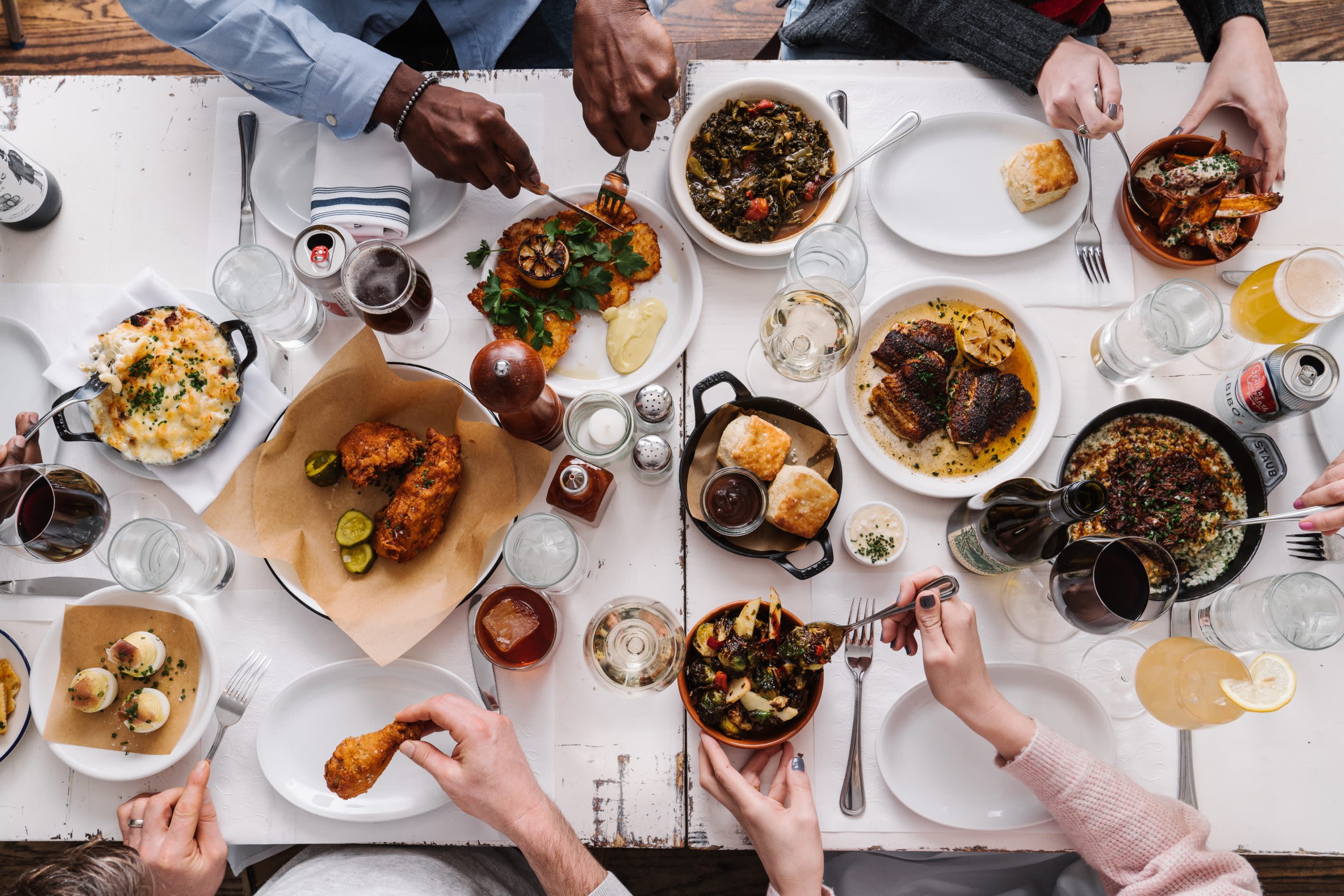 Table with guests enjoying Southern food at JCT. Kitchen.