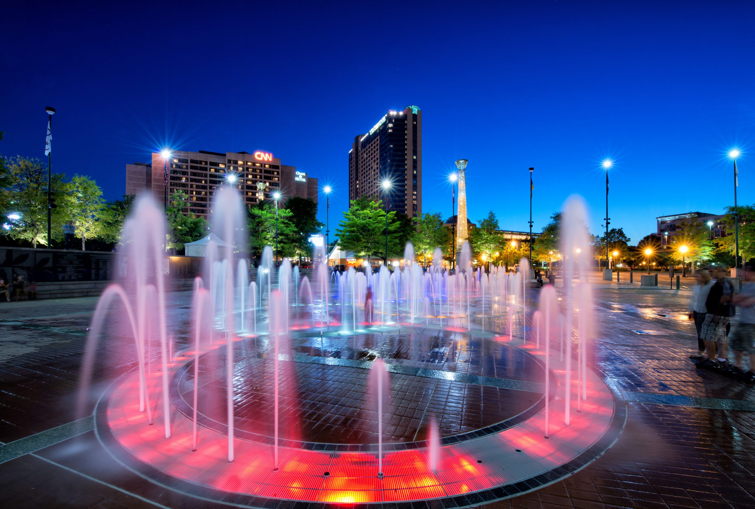 The Fountain of Rings at Centennial Olympic Park at dusk with CNN in the background