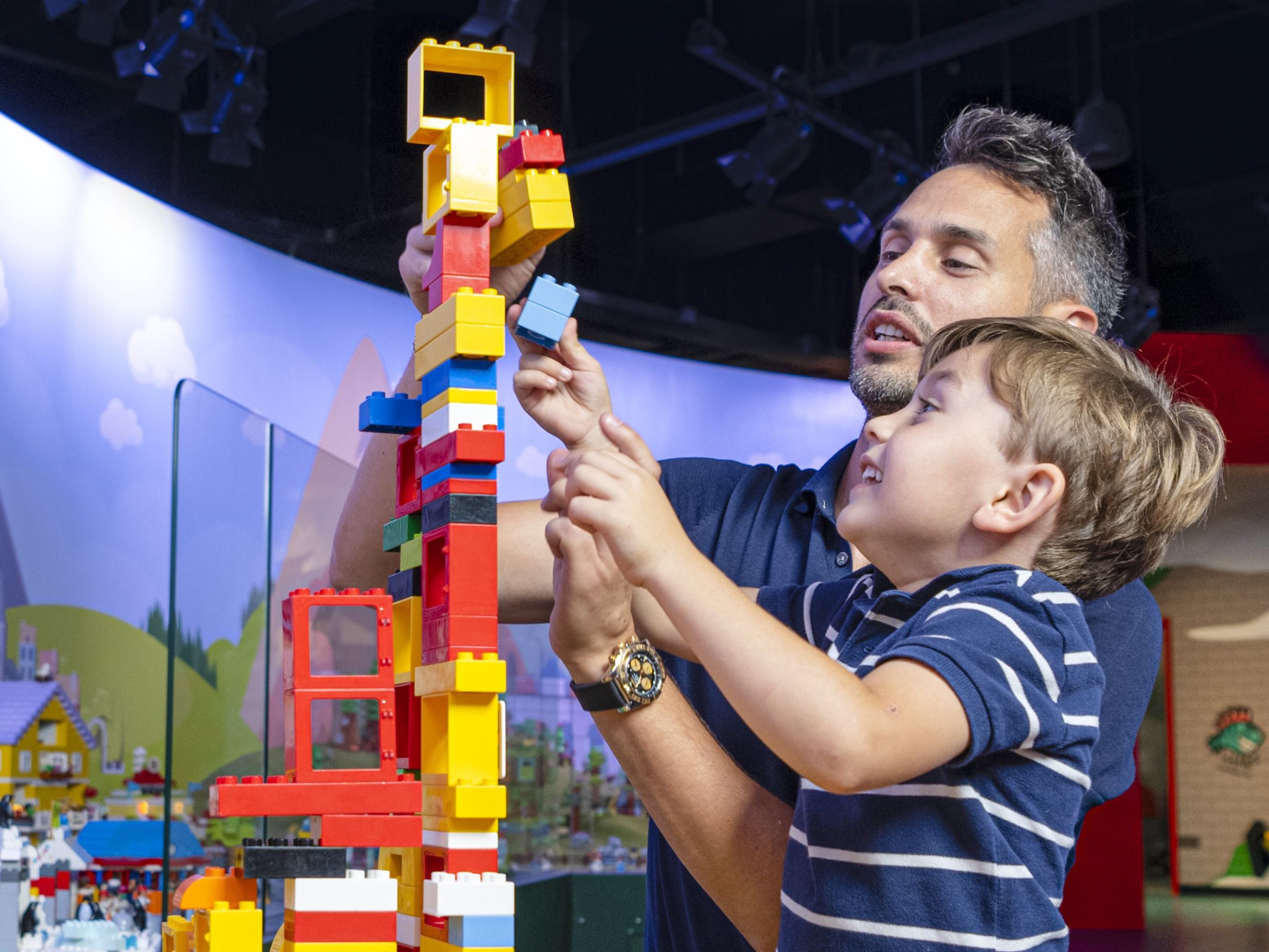Father and son building with LEGO at LEGO Discovery Center Atlanta in Phipps Plaza.