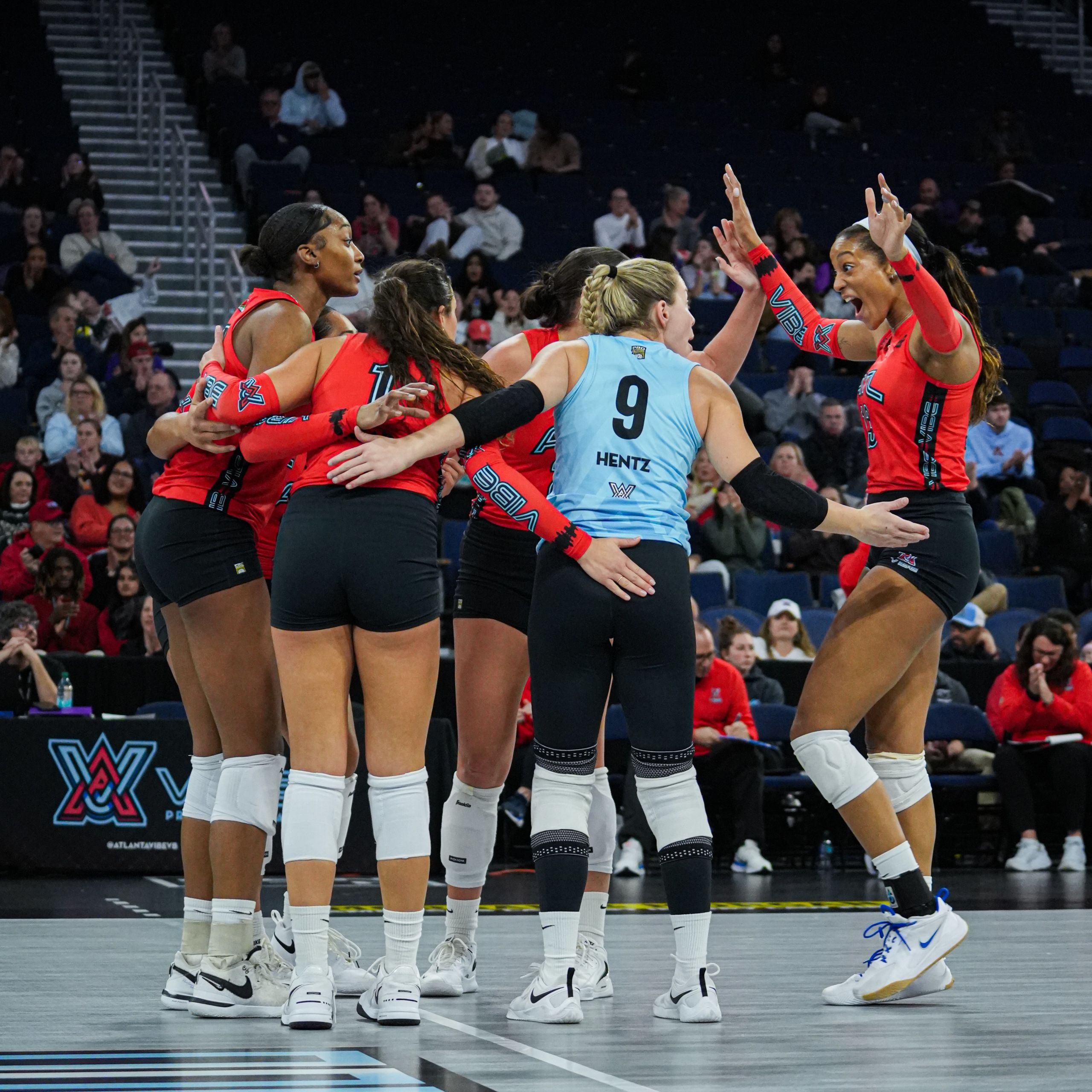 group of volleyball players huddle