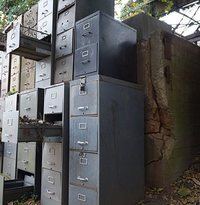 Lauri Stallings 2 A row of old, rusty filing cabinets stacked against a crumbling concrete wall in Atlanta, Georgia.