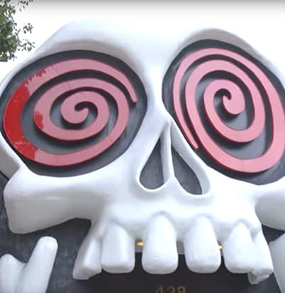 Ruby Velle and the Soulphonics 1 A large, stylized white skull with red spiral eyes and jagged teeth in Atlanta, Georgia.