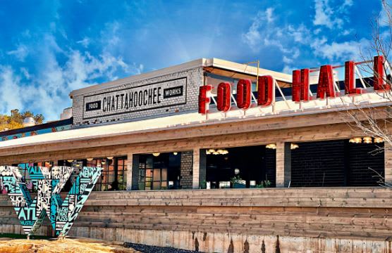Explore Top Things to Do in Atlanta’s Westside 7 A modern restaurant building with a large sign reading 'Food Hall' and colorful graffiti art in Atlanta, Georgia.
