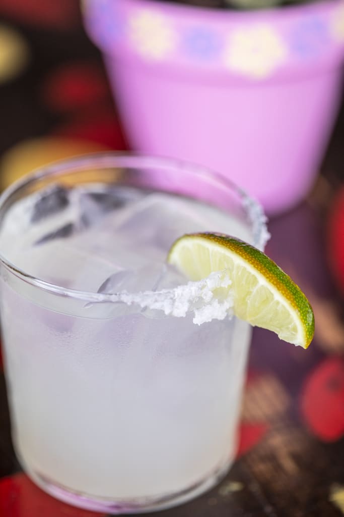 A refreshing margarita with a lime wedge and salt rim in a glass on a colorful table in Atlanta, Georgia.