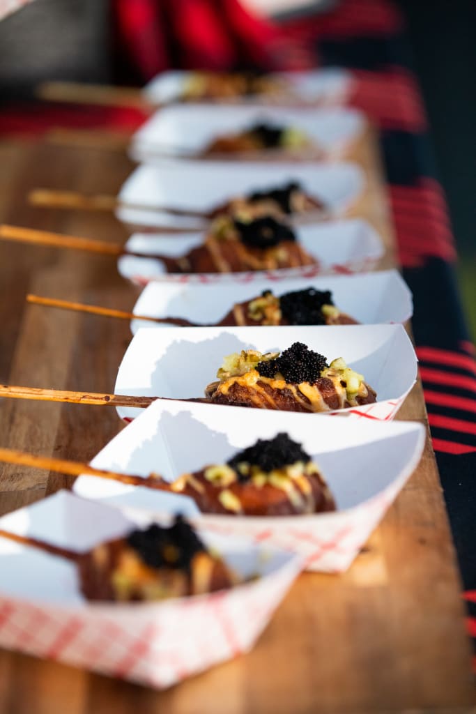 Taste Atlanta’s International Food Culture at the 2025 Food & Wine Festival 2 A row of paper boats filled with skewered food topped with black caviar in Atlanta, Georgia.