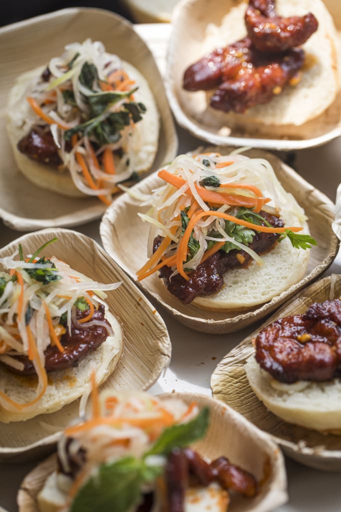 Taste Atlanta’s International Food Culture at the 2025 Food & Wine Festival 4 Assorted small sliders with various toppings on wooden plates in Atlanta, Georgia.