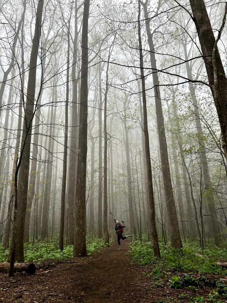 A woman posing in the trees on her hike outside Atlanta.