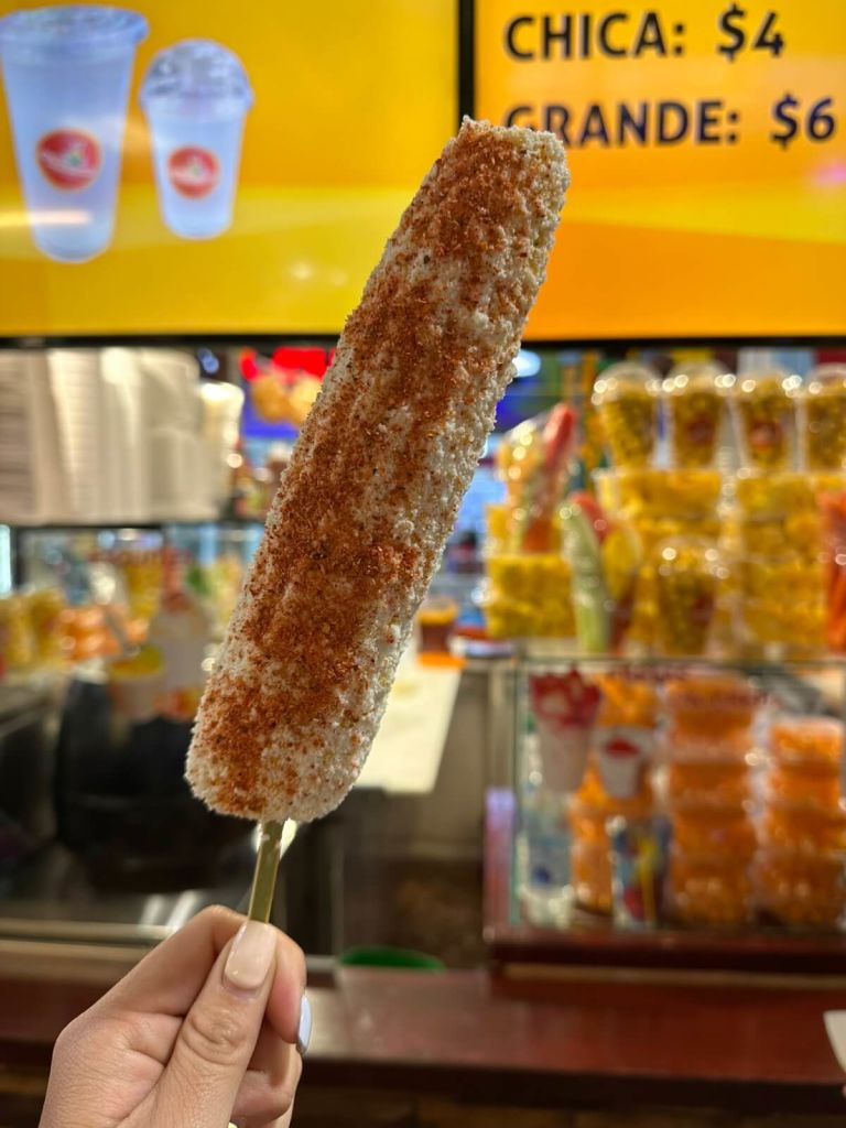 Ultimate Guide to Authentic Mexican Food in Atlanta 4 A hand holds a large, colorful ice cream cone with a textured coating in Atlanta, Georgia.