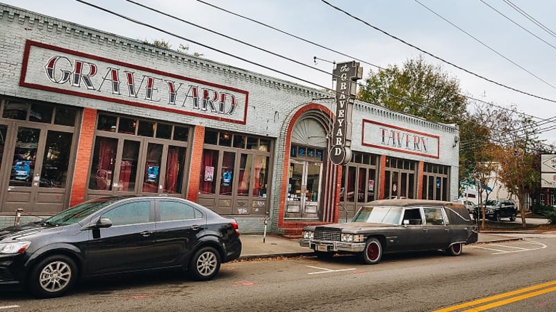 Cool, Funky Neighborhood: East Atlanta Village 6 A vintage hearse is parked in front of a retro-style bar and tavern called 'Grave Yard' in Atlanta, Georgia.
