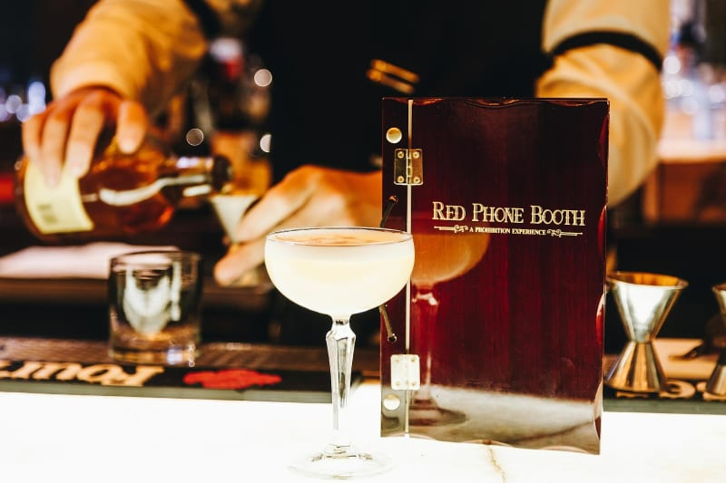 Hidden Bars and Speakeasies in Atlanta You Should Know 8 A bartender pours a creamy yellow cocktail into a martini glass at a bar in Atlanta, Georgia.