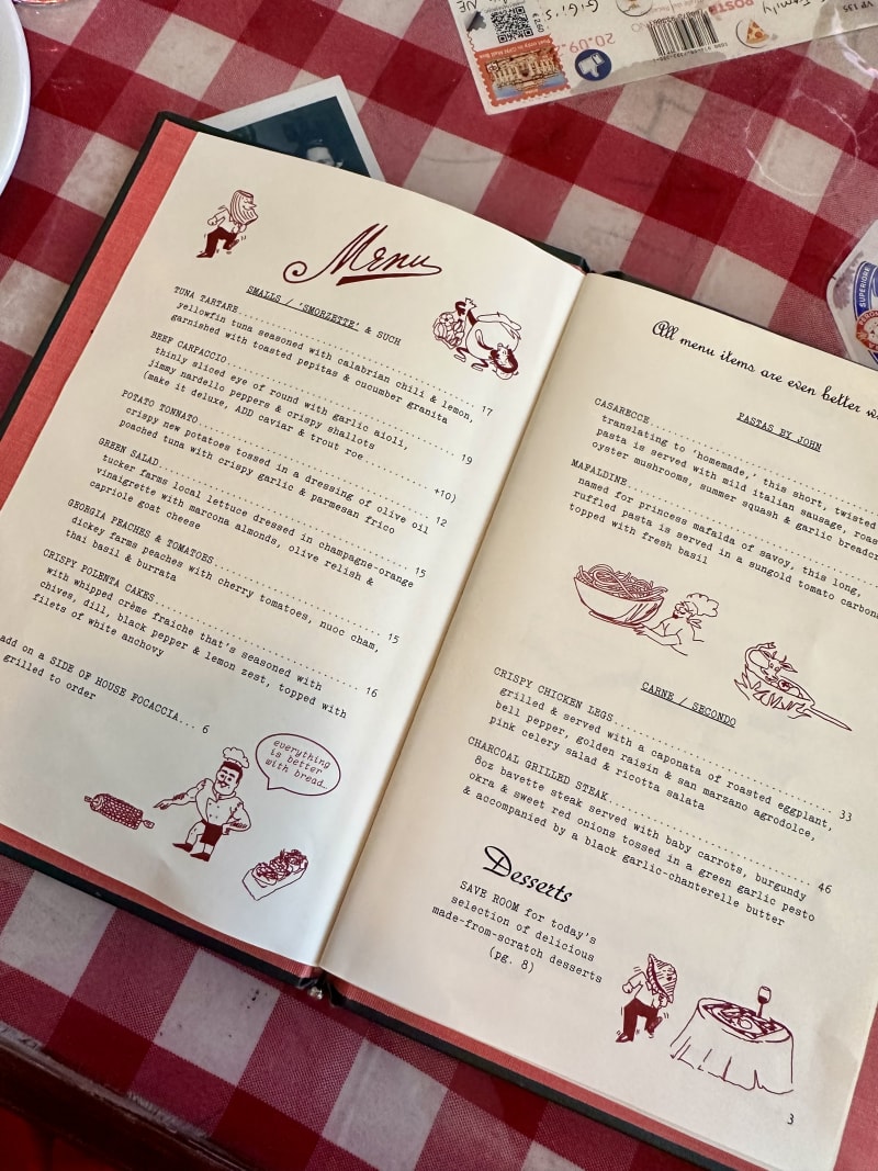 Inside Gunshow Restaurant: How Chef Cody Chassar Leads an Atlanta Icon 9 Open menu book on red and white checkered tablecloth with food items and illustrations in Atlanta, Georgia.