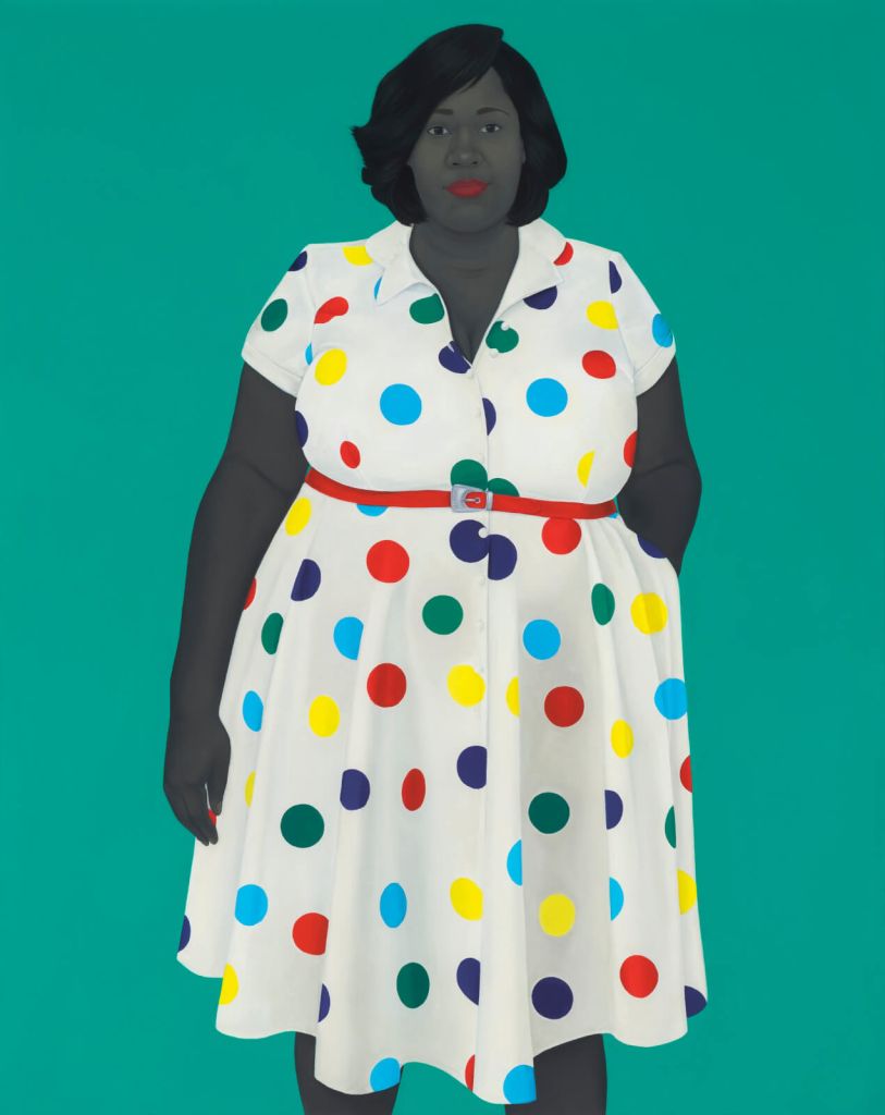 A woman with dark skin and black hair is wearing a vibrant white dress adorned with colorful polka dots of various sizes, paired with a red belt and black gloves in Atlanta, Georgia.