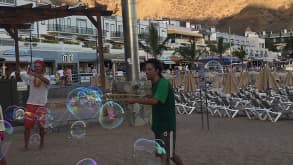 Puerto de Mogán - We previously visited Gran Canaria but stayed in a different area. We absolutely fell in love with Puerto de Mogan and knew we had to come back and stay here. - Street performers blowing bubbles by the beach