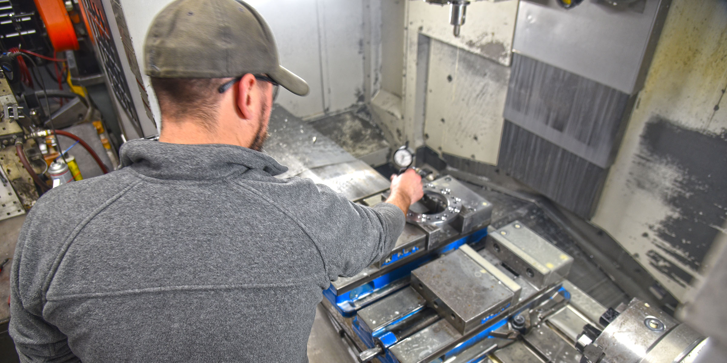 Two A to Z Machine employees looking at screen on a CNC Machine