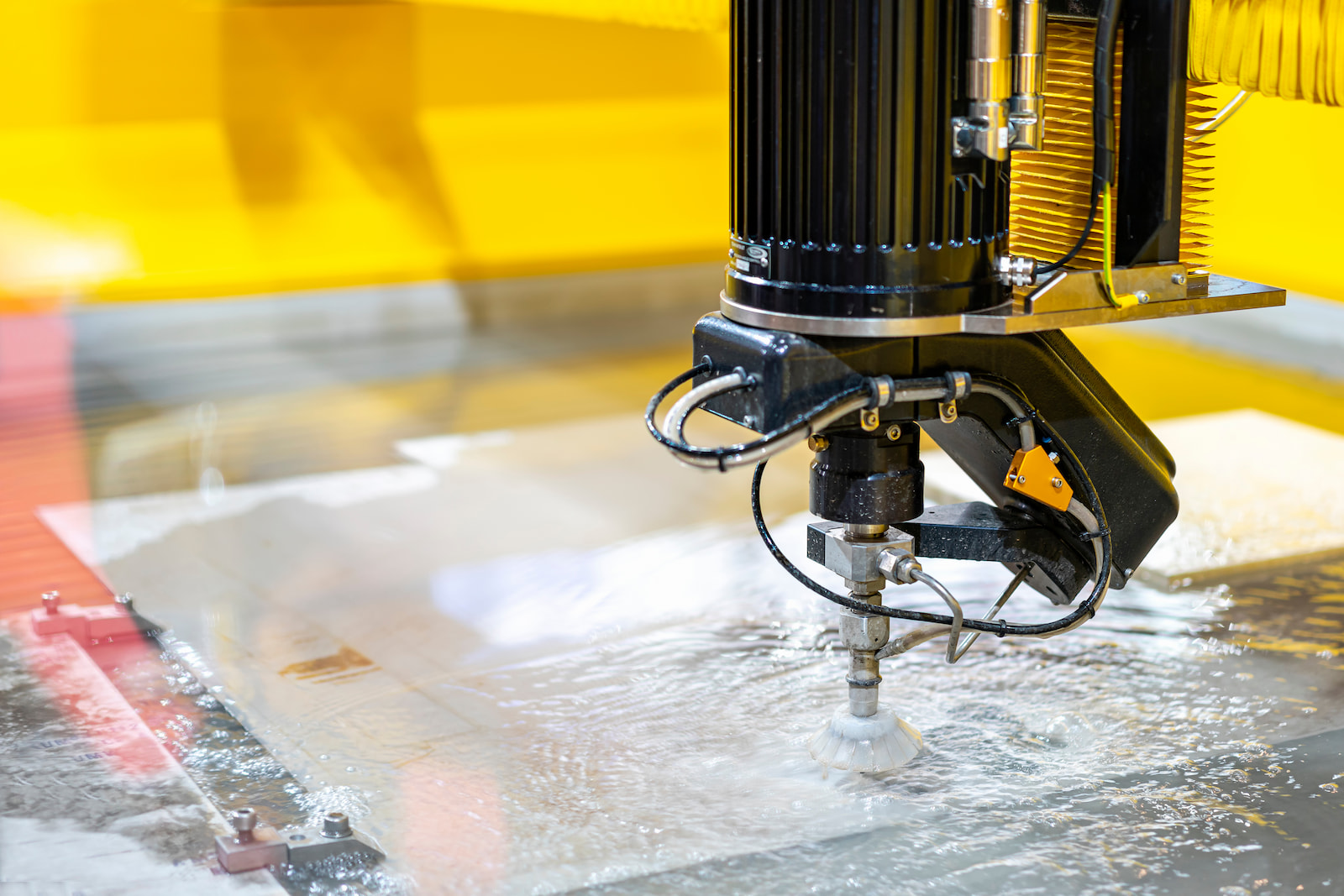 Industrial waterjet cutting machine performing precision metal fabrication services in Appleton, WI.