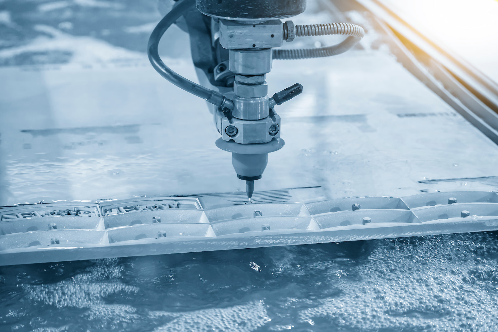 Precision waterjet cutting machine fabricating custom industrial components in Appleton, WI.