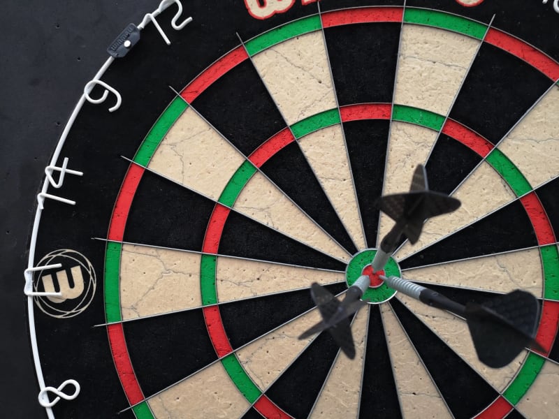 Three darts in the bullseye. Targeting great search results by using search intent (Photo by Michiel from Pexels: https://www.pexels.com/photo/a-close-up-shot-of-a-dartboard-with-darts-on-the-bullseye-10680031/).