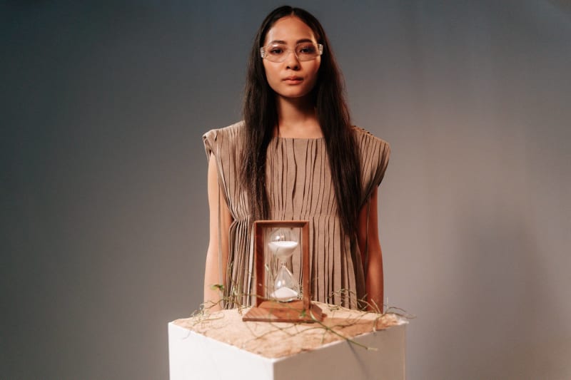 Asian woman with hourglass timer. Time is running out. (Photo by Ron Lach from Pexels: https://www.pexels.com/@ron-lach/gallery/).