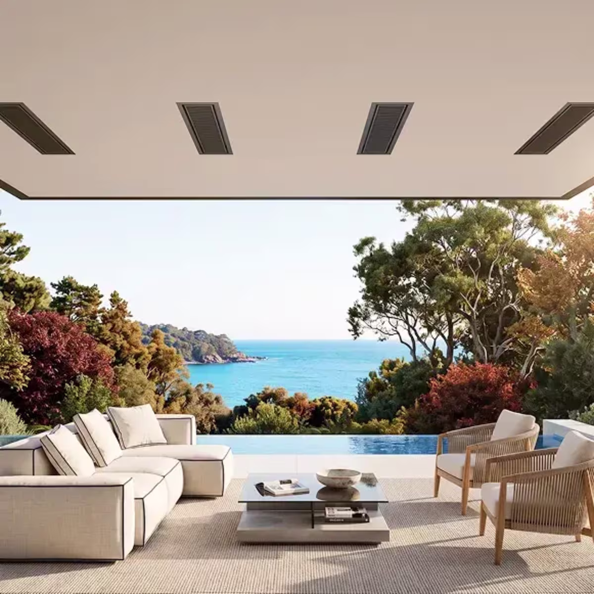 Ceiling-mounted patio heaters above a modern outdoor lounge overlooking an infinity pool and ocean.
