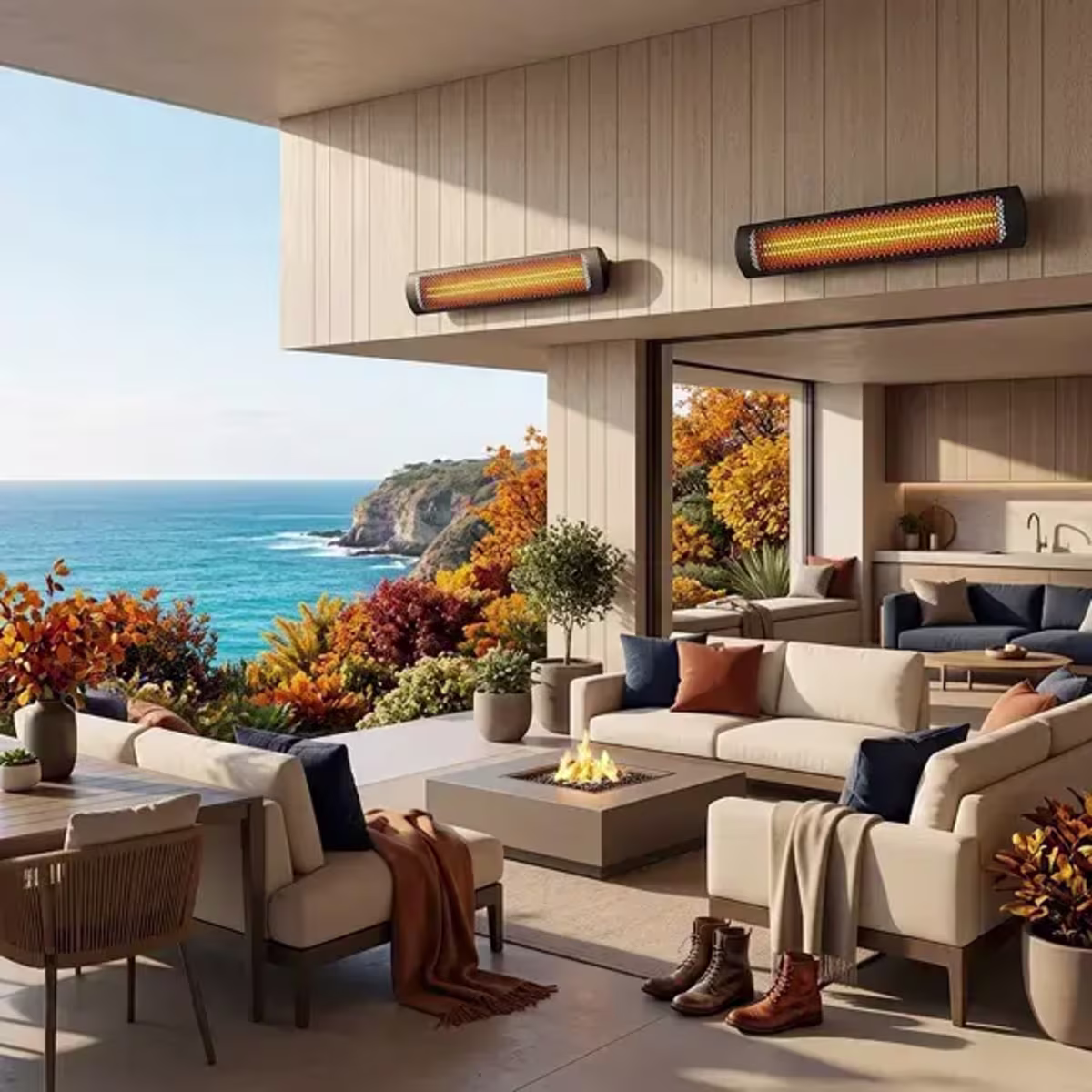 Two wall-mounted patio heaters above a cozy outdoor lounge with a fire pit and coastal view.