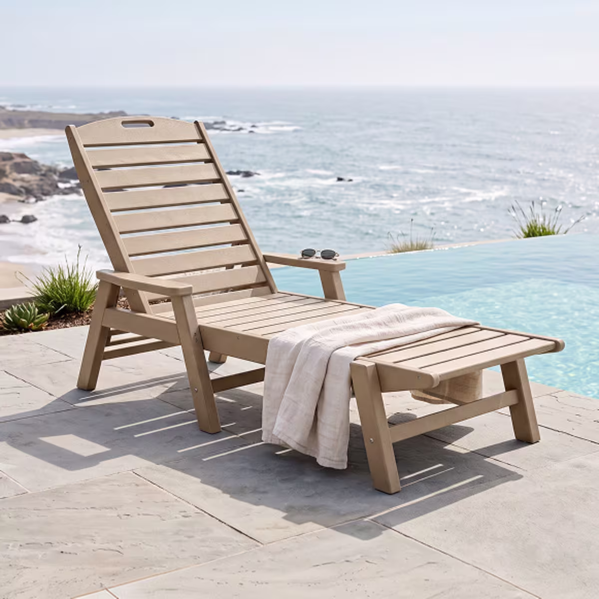 Tan outdoor chaise lounge beside pool.