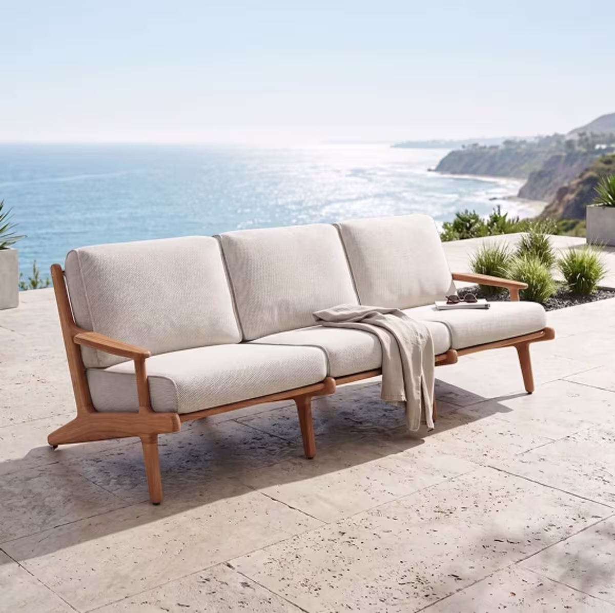 Wooden patio sofa overlooking the ocean.