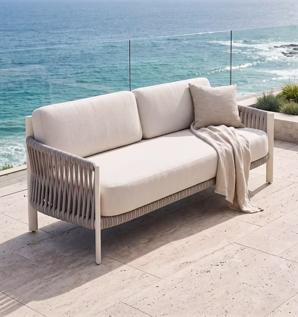 Rope-weave sofa with white cushions.