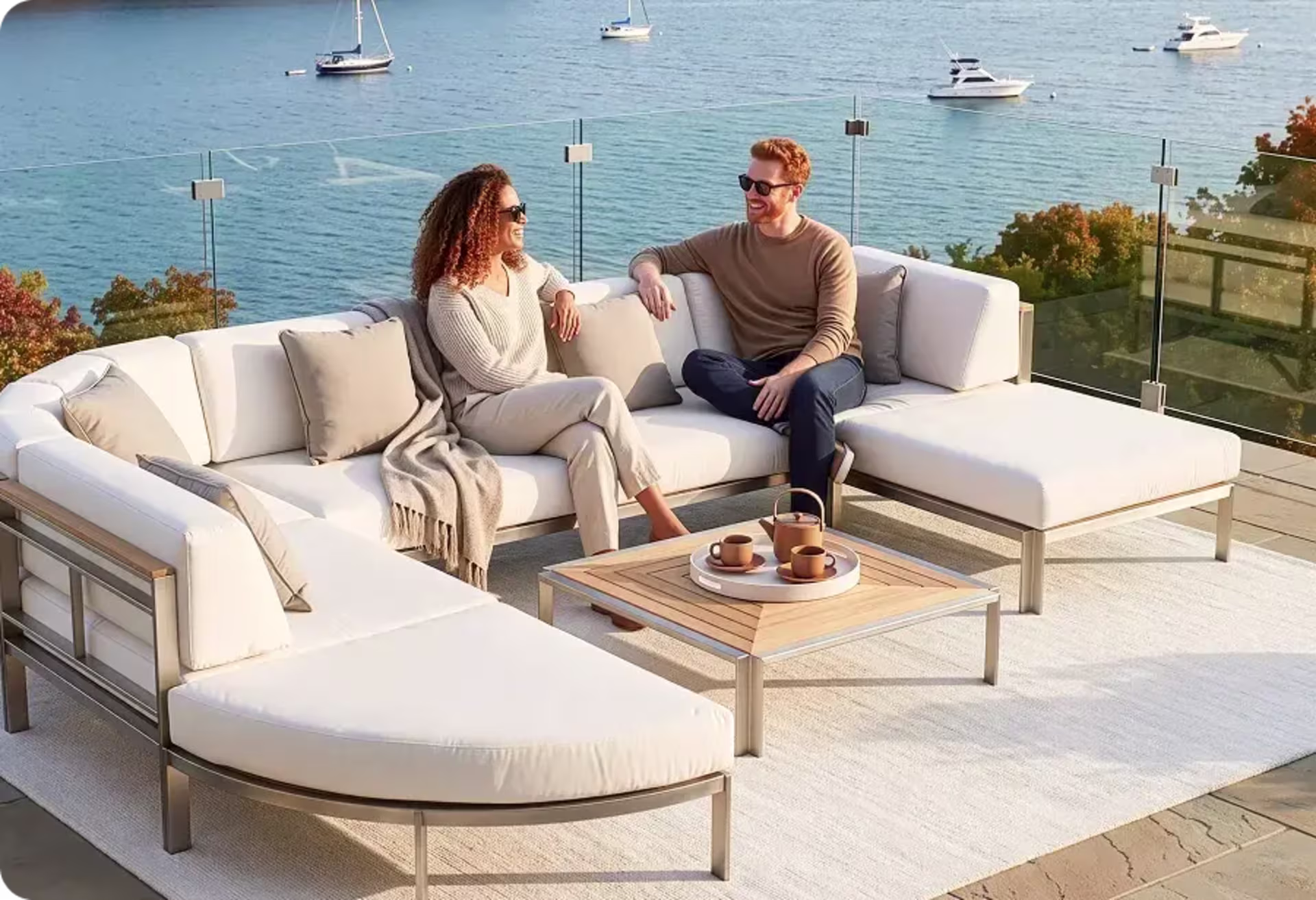 Couple relaxing on a white sectional overlooking the water. image