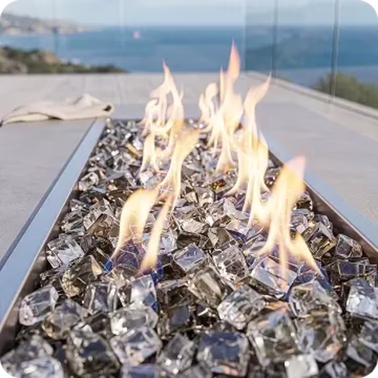 Flames rising through clear glass rocks.