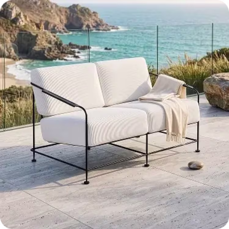 Modern cushioned outdoor metal loveseat.