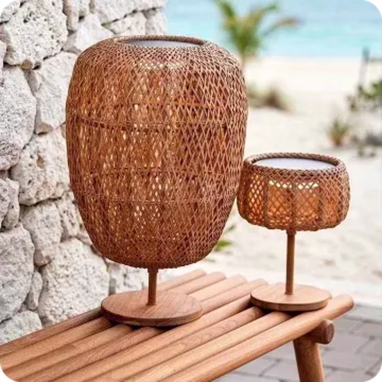 Woven rattan lanterns on wooden bench.