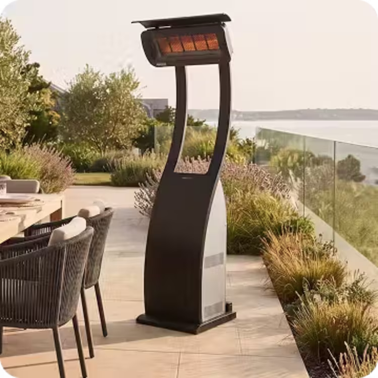Freestanding patio heater beside an outdoor dining area overlooking the coast.