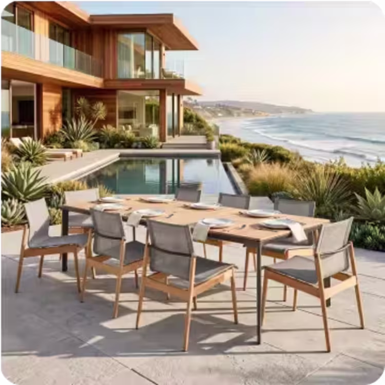 Contemporary outdoor dining table with six chairs on a modern patio overlooking a pool and the ocean.