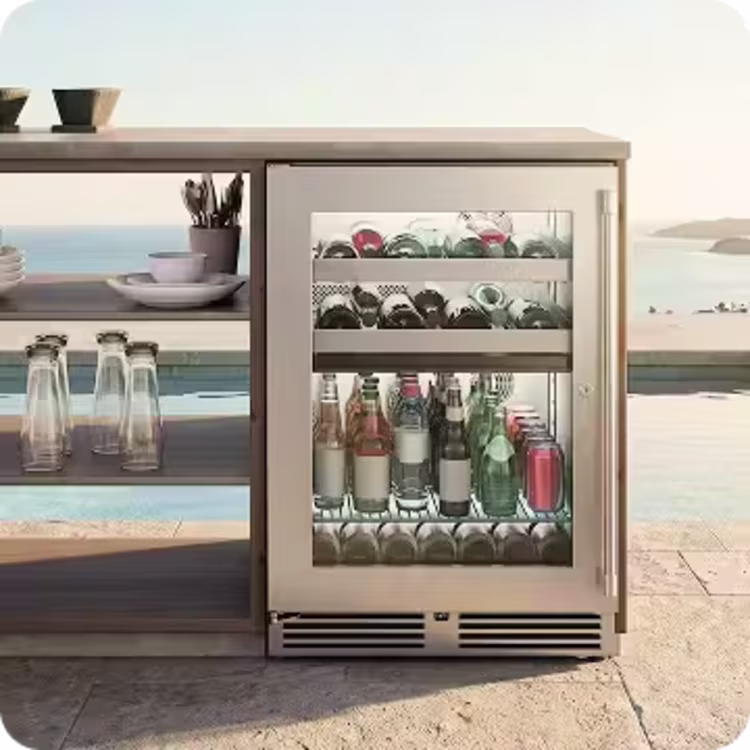 Built-in outdoor beverage refrigerator stocked with drinks beneath a contemporary outdoor countertop.