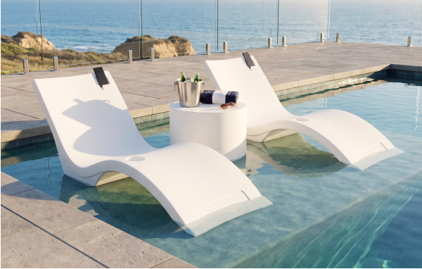 Floating Luxuries Kai shelf loungers partially submerged in an oceanfront pool