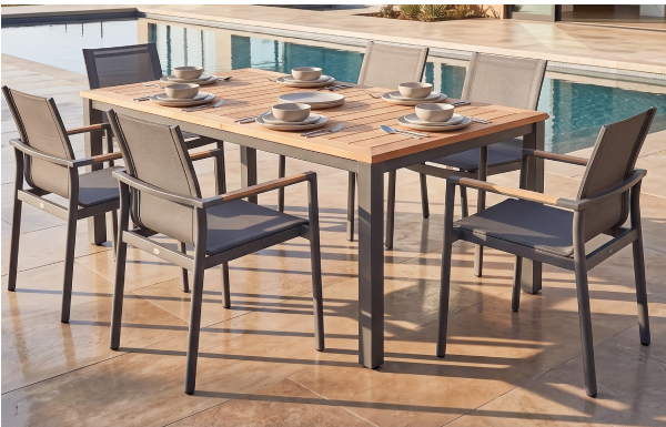 POVL Outdoor Qube dining armchairs arranged around a teak poolside table