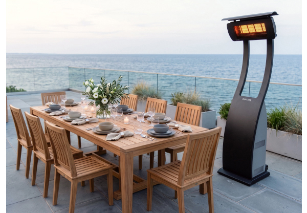 Bromic Tungsten portable gas patio heater beside an oceanfront dining table