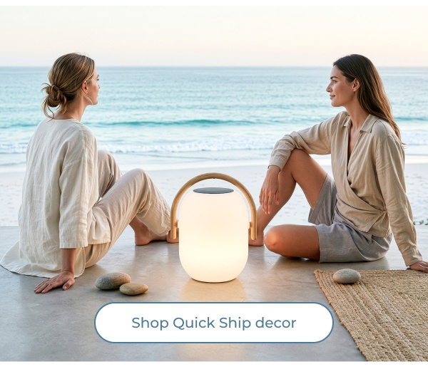 Women seated near glowing outdoor lantern. Image Text: Shop Quick Ship decor