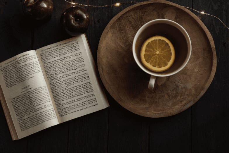 photo of cup of tea with book