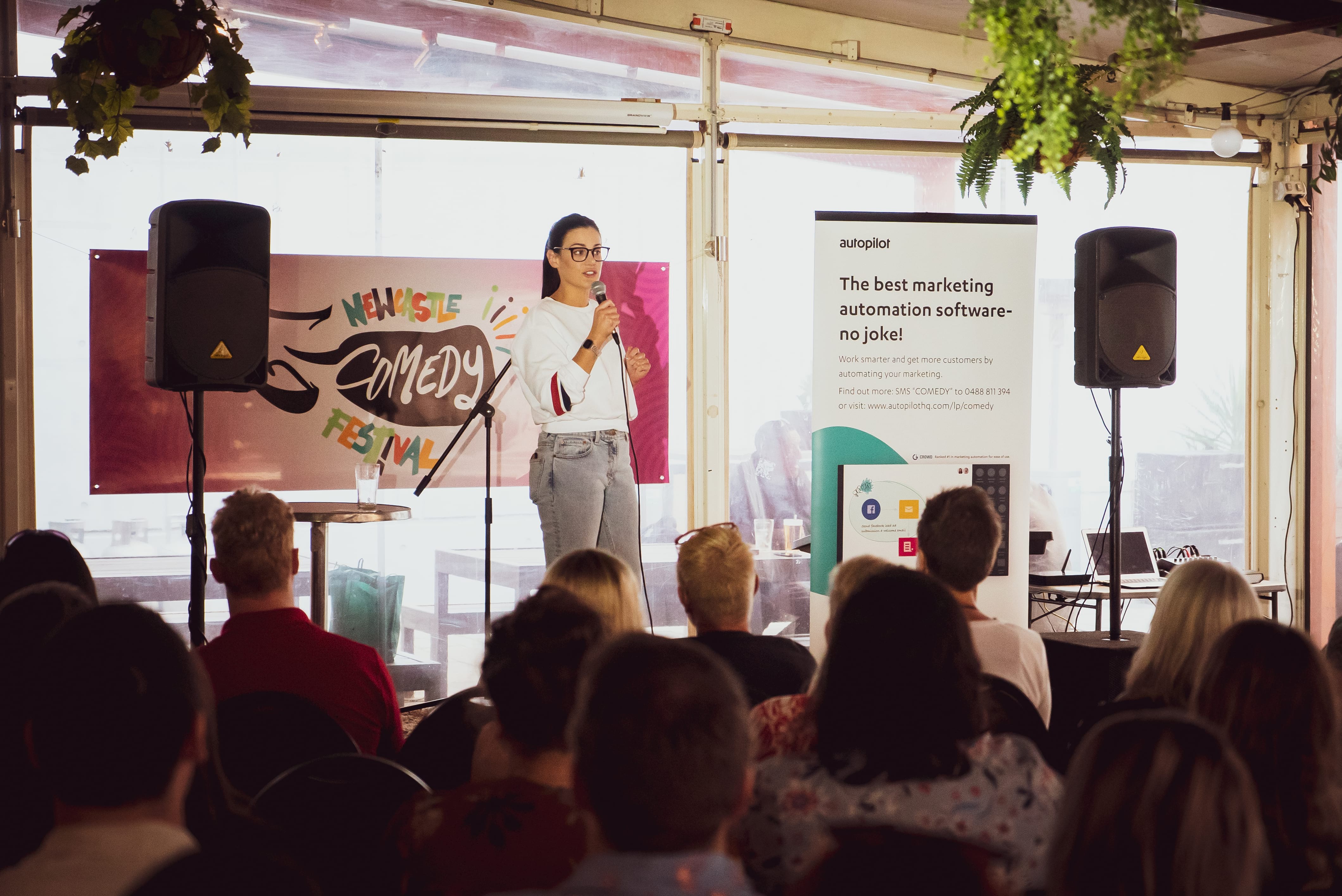 female comedian on stage performing at newcastle comedy festival
