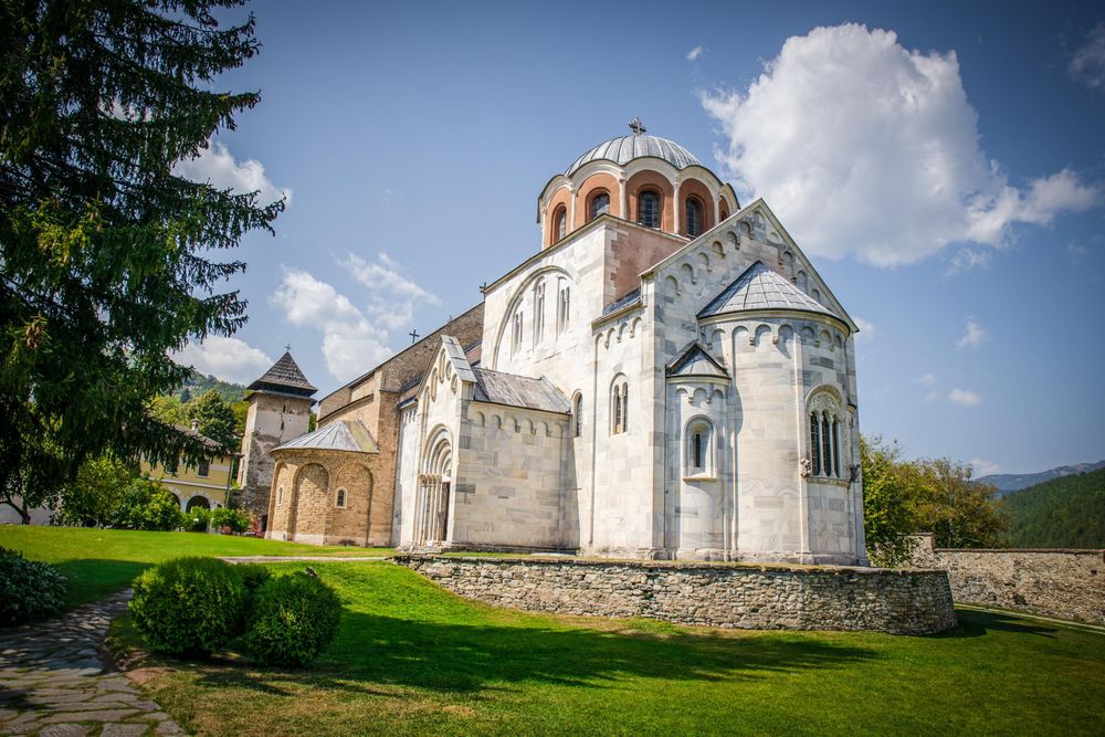 Studenica Monastery with its light-stone church surrounded by greenery