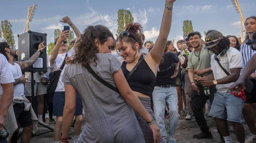 People dancing together in Berlin’s Mauerpark