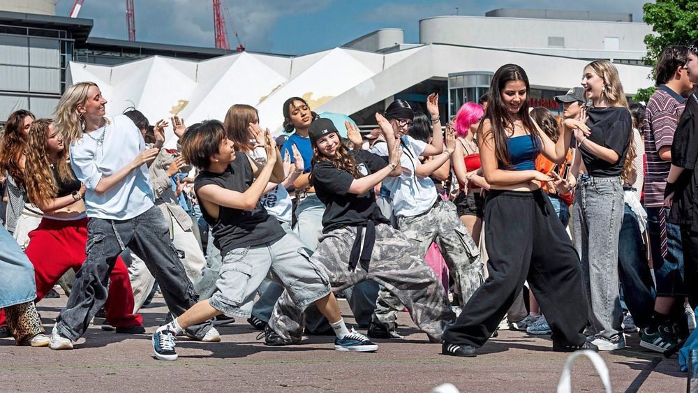 A group of young people dancing at a K-pop event on Alexanderplatz in Berlin