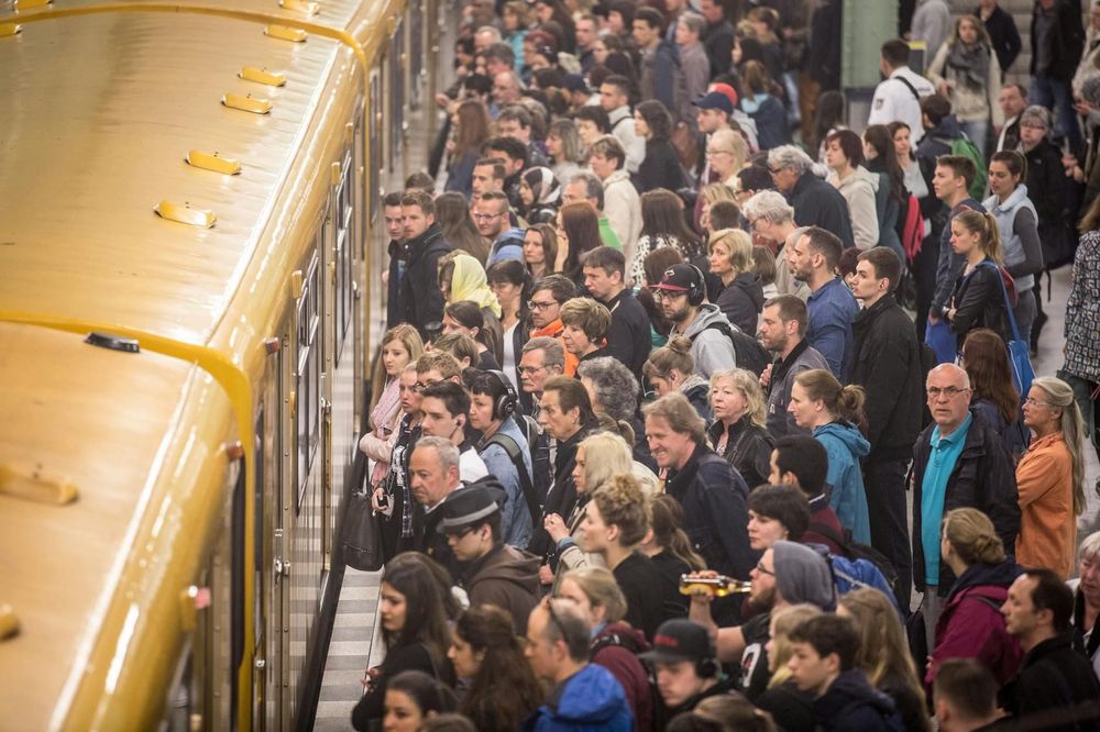 A large crowd of passengers on an U-Bahn platform at Alexanderplatz in Berlin