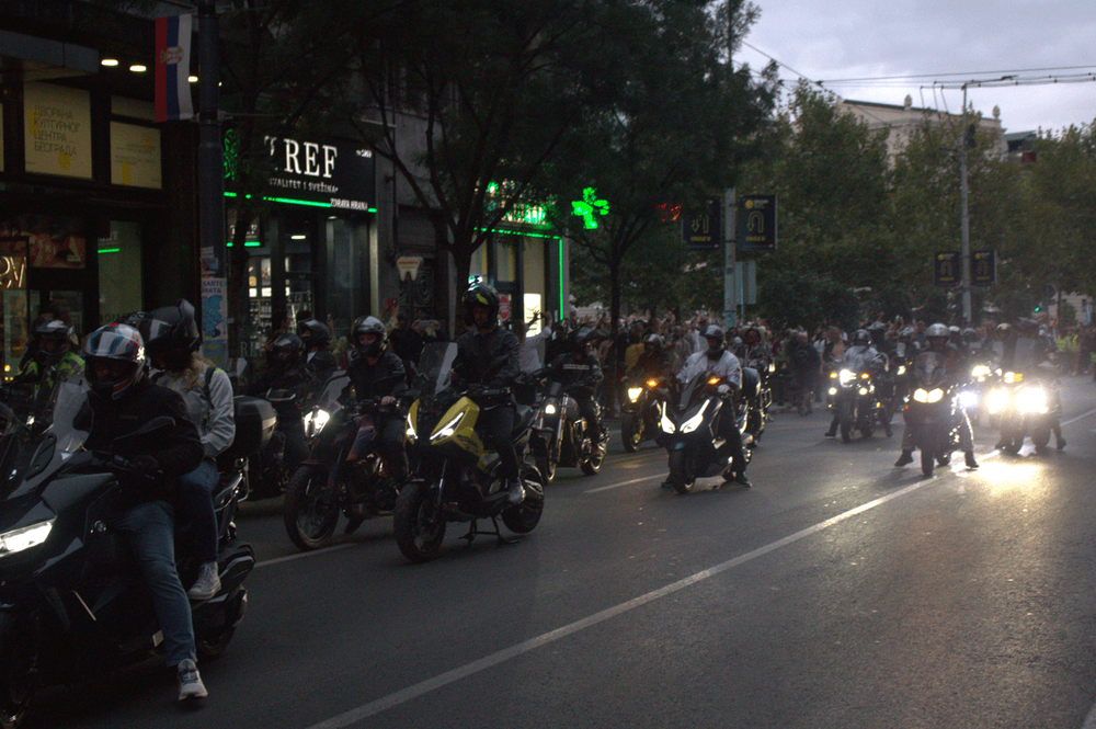 A large group of motorcyclists rides through central Belgrade during the student procession