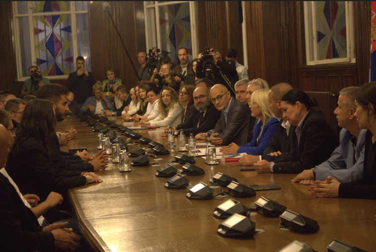 Representatives of the Student List and members of the Republic Electoral Commission sit on opposite sides of the table during the submission of documentation