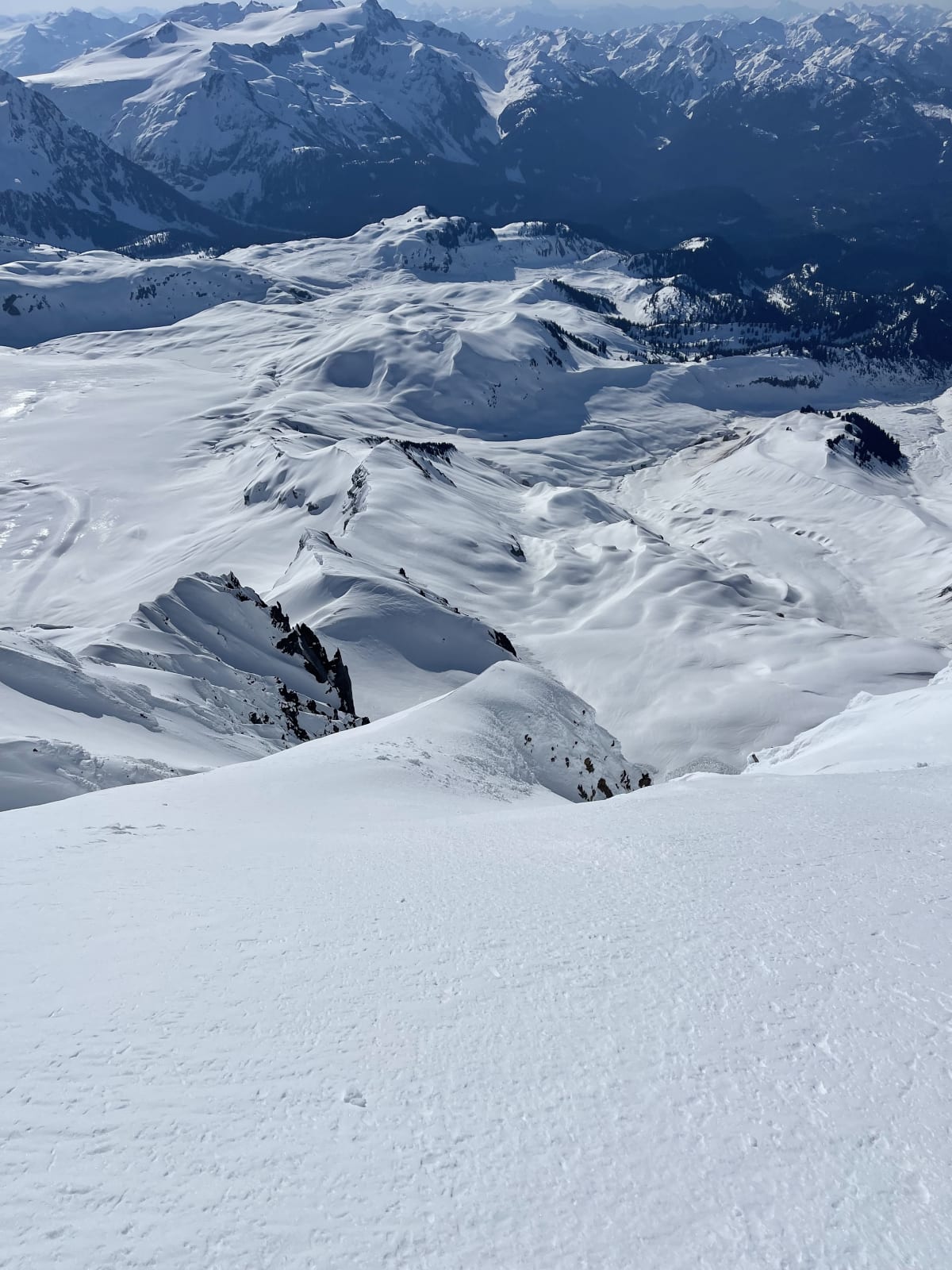 View from the top of the ski line. Upper snowfield, looking down. Line drops into the couloir