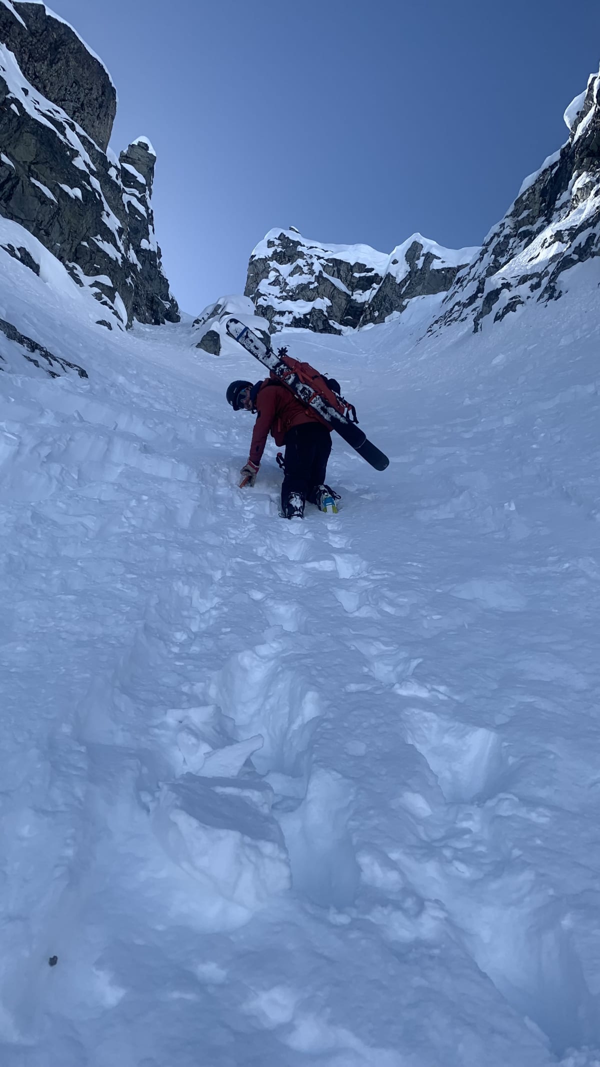 Bootpacking in punchy conditions. We would soon encounter a waist-deep facet bath, making upward progress extremely difficult. We transitioned to ski about 10m below the top.