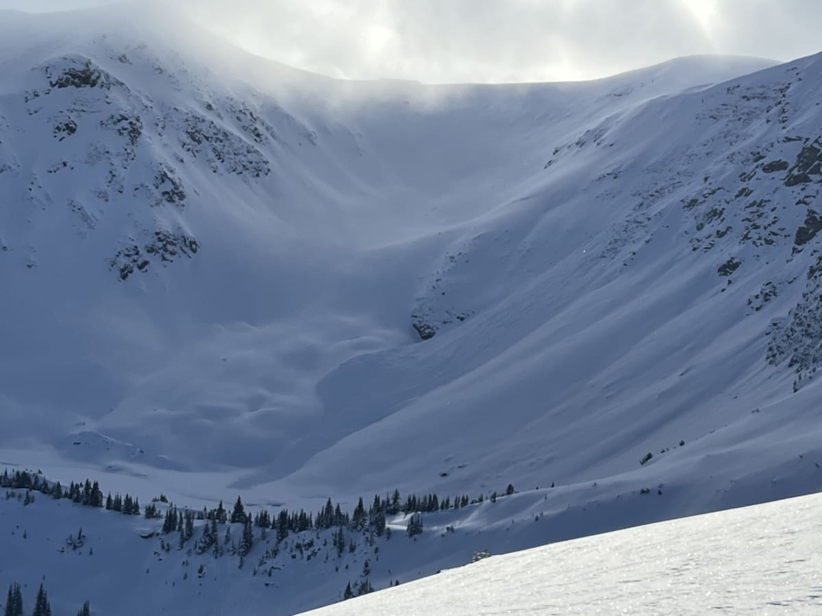 East facing aspect 2500m. Large cornice failure entraining loose snow on rocks but not pulling slab.